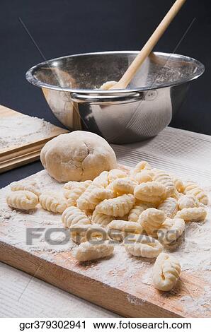 Close-up of gnocchi on a cutting board View Large Photo Image Stock Image - Close-up of gnocchi on a cutting board. Fotosearch