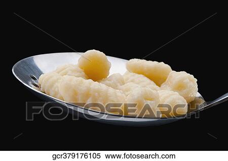 Close-up of gnocchi on a spoon View Large Photo Image Stock Photography - Close-up of gnocchi on a spoon. Fotosearch
