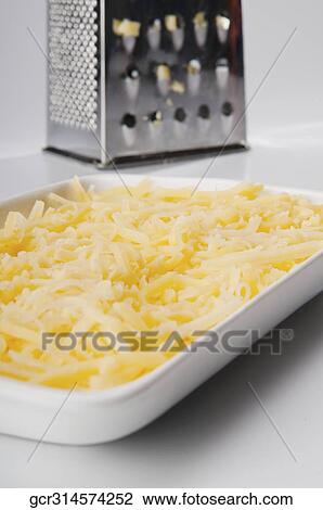 Stock Image - Close-up of grated parmesan cheese. Fotosearch