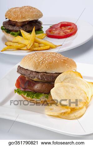 Stock Image - Close-up of hamburgers with chips. Fotosearch