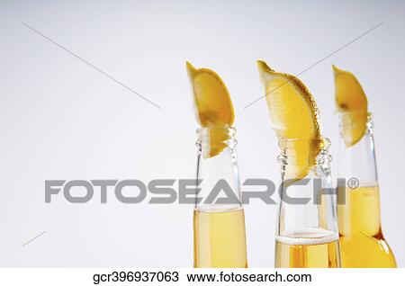 Close-up of lemon wedges in beer bottles View Large Photo Image Stock Image - Close-up of lemon wedges in beer bottles. Fotosearch