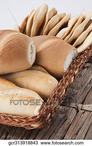 Stock Image - Close-up of loaves of bread in a basket. Fotosearch