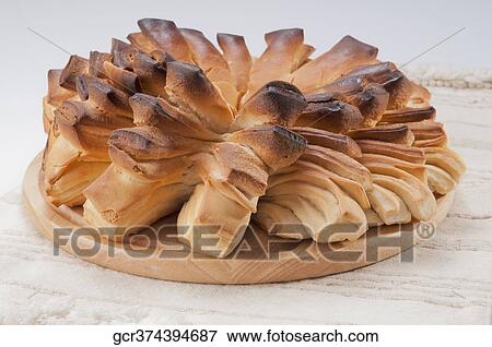 Stock Photo - Close-up of loaves of bread in a cutting board. Fotosearch