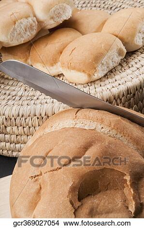 Close-up of loaves of bread with a knife View Large Photo Image Picture - Close-up of loaves of bread with a knife. Fotosearch