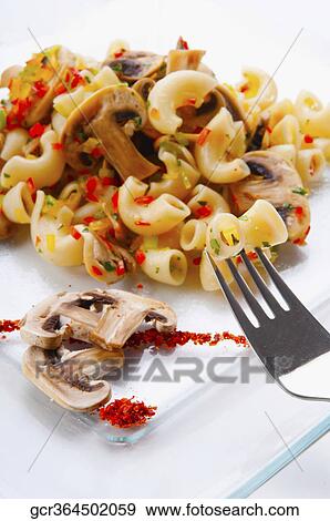 Close-up of macaroni and mushrooms on a platter View Large Photo Image Stock Photo - Close-up of macaroni and mushrooms on a platter. Fotosearch
