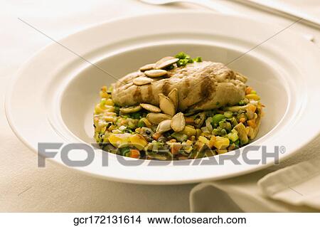 Picture - Close-up of melon seeds garnish on a dish. Fotosearch