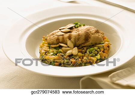 Stock Image - Close-up of melon seeds garnish on a dish. Fotosearch