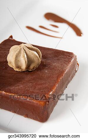 Stock Image - Close-up of meringue on chocolate cake. Fotosearch