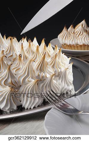Close-up of meringue pies with a cake server View Large Photo Image Stock Image - Close-up of meringue pies with a cake server. Fotosearch