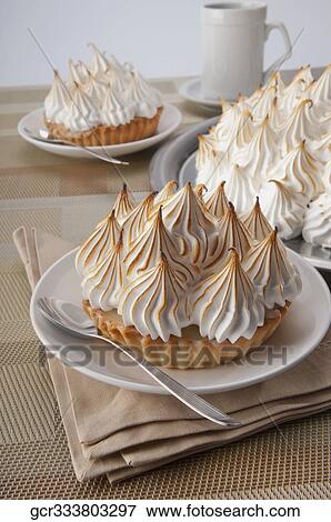 Close-up of meringue pies with a cup of coffee View Large Photo Image Stock Photo - Close-up of meringue pies with a cup of coffee. Fotosearch