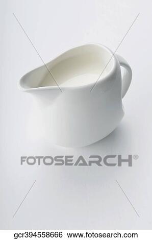 Close-up of milk in a white ceramic jug View Large Photo Image Stock Photograph - Close-up of milk in a white ceramic jug. Fotosearch