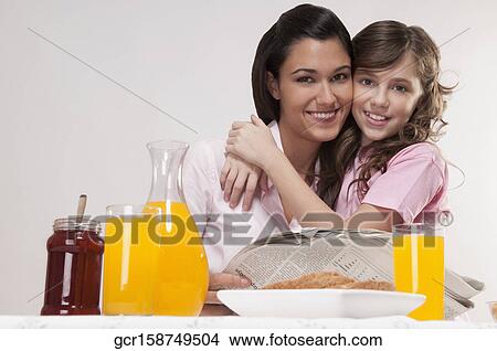 Picture - Close-up of mother and daughter at the breakfast table. Fotosearch
