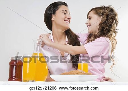 Close-up of mother and daughter at the breakfast table View Large Photo Image Stock Photograph - Close-up of mother and daughter at the breakfast table. Fotosearch