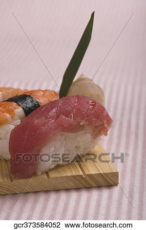 Close-up of nigiri sushi on a cutting board View Large Photo Image Stock Image - Close-up of nigiri sushi on a cutting board. Fotosearch