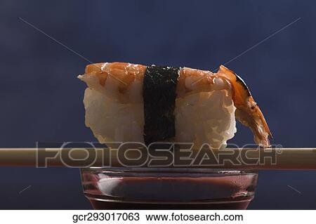 Close-up of Nigiri Sushi with chopsticks on a bowl of soy sauce View Large Photo Image Stock Image - Close-up of Nigiri Sushi with chopsticks on a bowl of soy sauce. Fotosearch