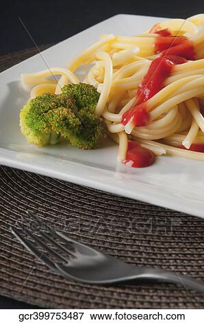 Close-up of noodles topped with tomato sauce View Large Photo Image Stock Photo - Close-up of noodles topped with tomato sauce. Fotosearch