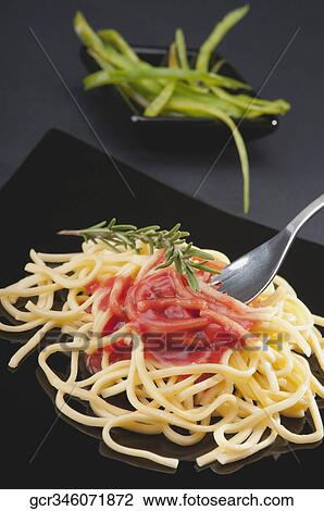 Close-up of noodles with tomato sauce View Large Photo Image Stock Image - Close-up of noodles with tomato sauce. Fotosearch