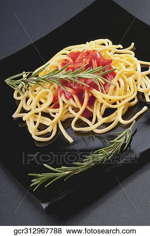 Close-up of noodles with tomato sauce View Large Photo Image Stock Photo - Close-up of noodles with tomato sauce. Fotosearch