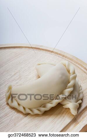 Close-up of panzerotti on a wooden board View Large Photo Image Stock Image - Close-up of panzerotti on a wooden board. Fotosearch