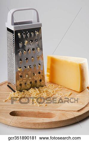 Close-up of parmesan cheese and a grater View Large Photo Image Stock Image - Close-up of parmesan cheese and a grater. Fotosearch