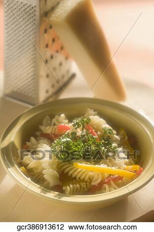 Close-up of pasta in a bowl with cheese grater View Large Photo Image Stock Image - Close-up of pasta in a bowl with cheese grater. Fotosearch
