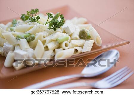 Close-up of pasta in a plate with tableware View Large Photo Image Stock Photo - Close-up of pasta in a plate with tableware. Fotosearch
