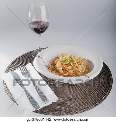 Close-up of pepper and basil garnished pasta with red wine View Large Photo Image Stock Image - Close-up of pepper and basil garnished pasta with red wine. Fotosearch