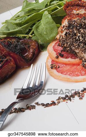 Close-up of pepper coated chops with grapefruit View Large Photo Image Stock Photo - Close-up of pepper coated chops with grapefruit. Fotosearch
