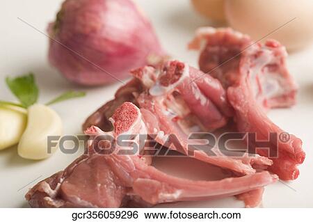 Close-up of pieces of mutton with onion and garlic cloves View Large Photo Image Stock Photograph - Close-up of pieces of mutton with onion and garlic cloves. Fotosearch