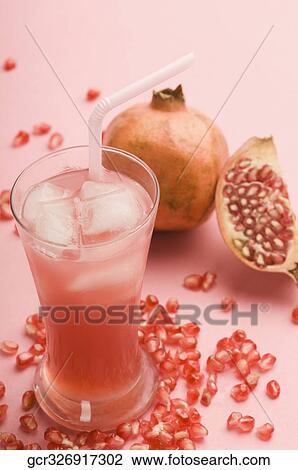 Close-up of pomegranate with a glass of pomegranate juice View Large Photo Image Stock Image - Close-up of pomegranate with a glass of pomegranate juice. Fotosearch