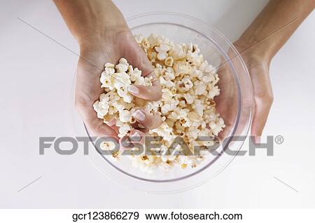 Close-up of popcorn in a woman's hands View Large Photo Image Stock Photo - Close-up of popcorn in a woman's hands. Fotosearch
