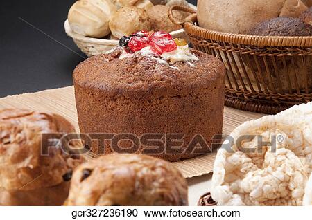 Stock Image - Close-up of raisin muffins and a fruit cake. Fotosearch