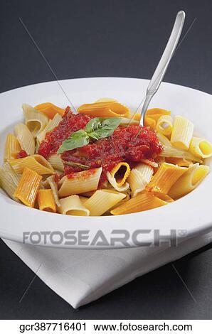 Close-up of rigatoni pasta topped with tomato concasse View Large Photo Image Stock Image - Close-up of rigatoni pasta topped with tomato concasse. Fotosearch