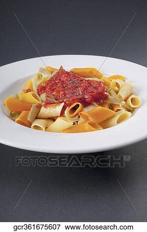 Close-up of rigatoni pasta topped with tomato concasse View Large Photo Image Stock Photo - Close-up of rigatoni pasta topped with tomato concasse. Fotosearch