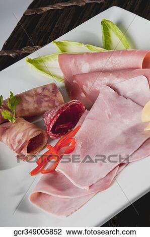 Close-up of salami with ham slices and salad on a plate View Large Photo Image Stock Image - Close-up of salami with ham slices and salad on a plate. Fotosearch