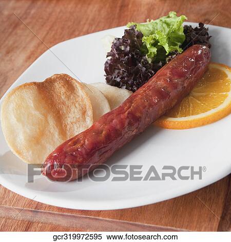 Stock Photography - Close-up of sausage with lettuce and fritters. Fotosearch