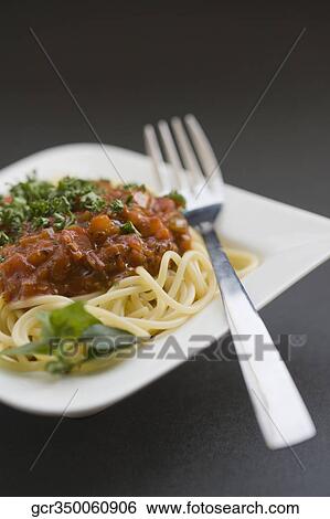 Close-up of spaghetti and meat with a fork View Large Photo Image Stock Photograph - Close-up of spaghetti and meat with a fork. Fotosearch