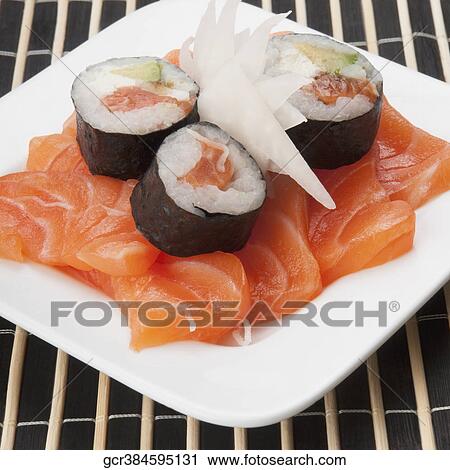 Close-up of sushi rolls on salmon slices View Large Photo Image Stock Image - Close-up of sushi rolls on salmon slices. Fotosearch