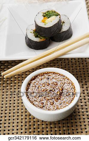 Close-up of sushi rolls with sesame seed dip View Large Photo Image Stock Photograph - Close-up of sushi rolls with sesame seed dip. Fotosearch
