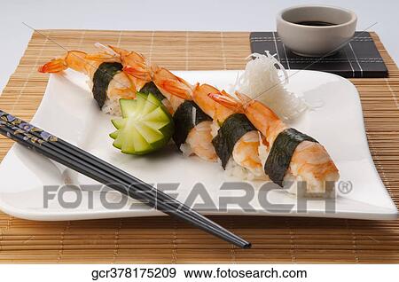 Close-up of sushi with chopsticks and soy sauce View Large Photo Image Stock Photo - Close-up of sushi with chopsticks and soy sauce. Fotosearch