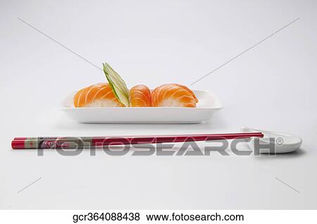 Close-up of sushi with chopsticks View Large Photo Image Stock Photo - Close-up of sushi with chopsticks. Fotosearch