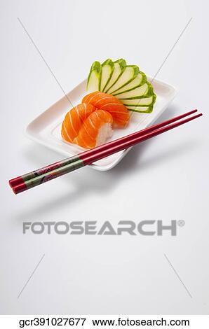 Close-up of sushi with chopsticks View Large Photo Image Stock Photo - Close-up of sushi with chopsticks. Fotosearch