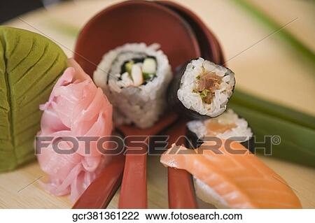 Close-up of sushi with ladles View Large Photo Image Stock Image - Close-up of sushi with ladles. Fotosearch