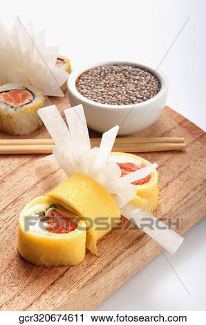 Close-up of sushi with sesame seeds in a bowl View Large Photo Image Stock Image - Close-up of sushi with sesame seeds in a bowl. Fotosearch
