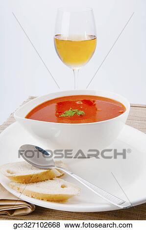 Stock Photo - Close-up of tomato soup served with white wine. Fotosearch