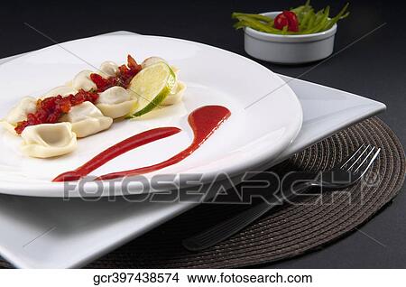 Close-up of tortelini garnished with tomato concasse View Large Photo Image Picture - Close-up of tortelini garnished with tomato concasse. Fotosearch