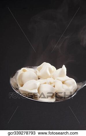 Close-up of tortellini on a spoon View Large Photo Image Stock Image - Close-up of tortellini on a spoon. Fotosearch