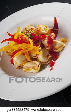 Close-up of tortellini served in a bowl View Large Photo Image Stock Photo - Close-up of tortellini served in a bowl. Fotosearch