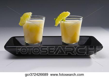 Close-up of two glass of sweet lime juice in a tray View Large Photo Image Stock Photo - Close-up of two glass of sweet lime juice in a tray. Fotosearch