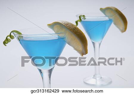 Close-up of two glasses of blue cocktail View Large Photo Image Stock Photo - Close-up of two glasses of blue cocktail. Fotosearch